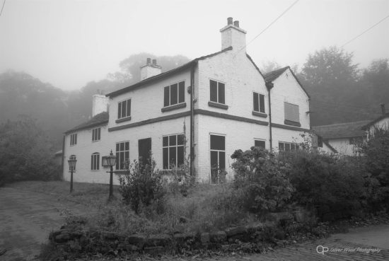 A black and white building in fog