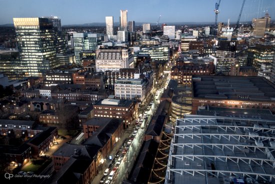A nighttime view of the city streets of Manchester 