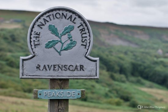 Ravenscar sign with green hills in the background
