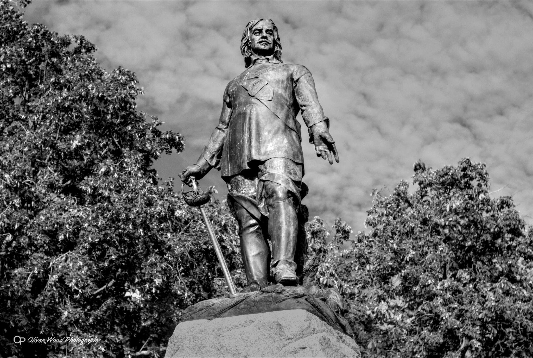 A black and white image of the bronze statue of Oliver Cromwell